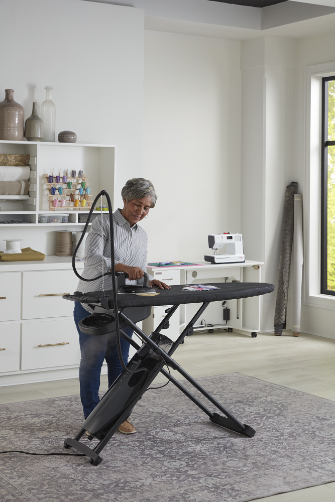 quilter pressing fabric in her sewing room